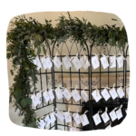 Prop Hire Bucks black room divider table plan for escort cards with green foliage and card name tags for wedding displays. Available in Buckinghamshire, Bedfordshire, Northamptonshire and Oxfordshire.